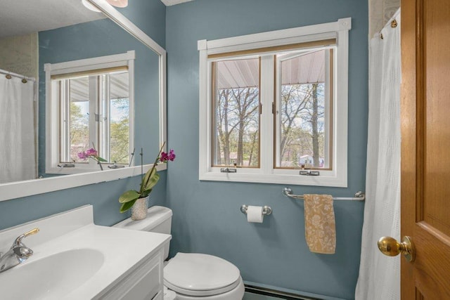 956 10th Ave SE, Forest Lake, MN 55025 - bathroom featuring baseboard heating, toilet, and vanity