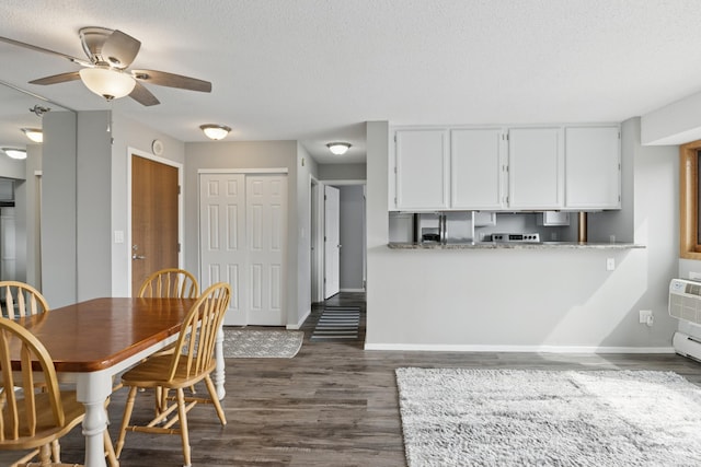 kitchen featuring ceiling fan, a textured ceiling, white cabinetry, baseboards, and dark wood-style floors