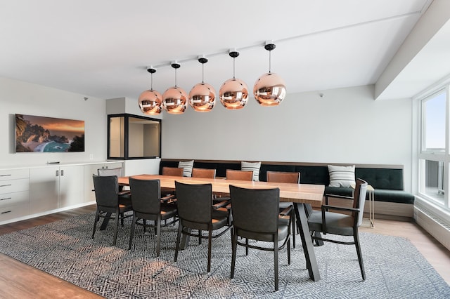 dining space with wood finished floors