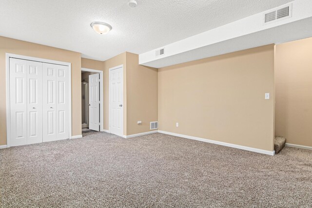 unfurnished bedroom featuring baseboards, visible vents, and carpet