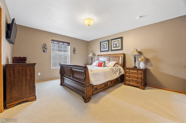 bedroom with light carpet and baseboards