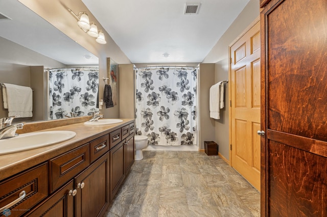 full bath with toilet, double vanity, and a shower with curtain