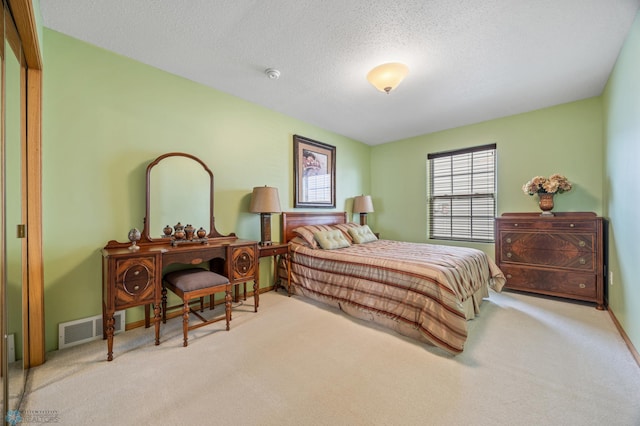 bedroom with carpet, a textured ceiling, and baseboards