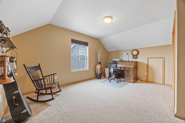 office area featuring vaulted ceiling, carpet floors, baseboards, and a textured ceiling