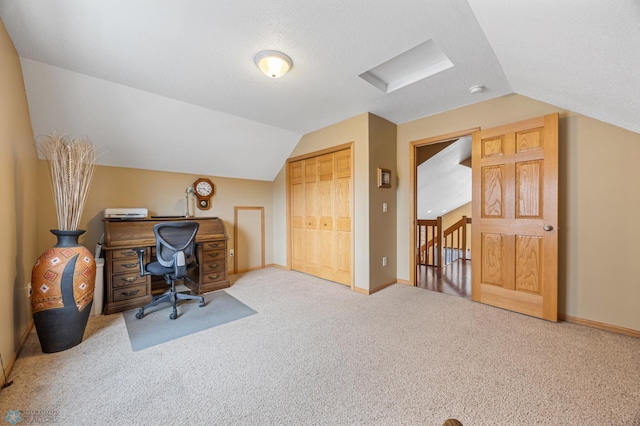 home office featuring vaulted ceiling, carpet flooring, and baseboards