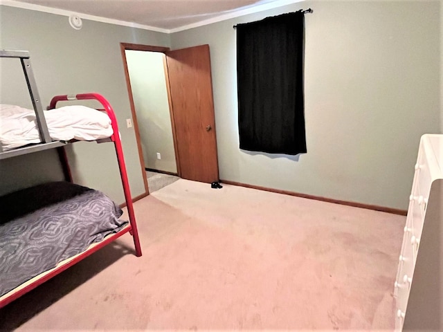 bedroom featuring ornamental molding, carpet, and baseboards