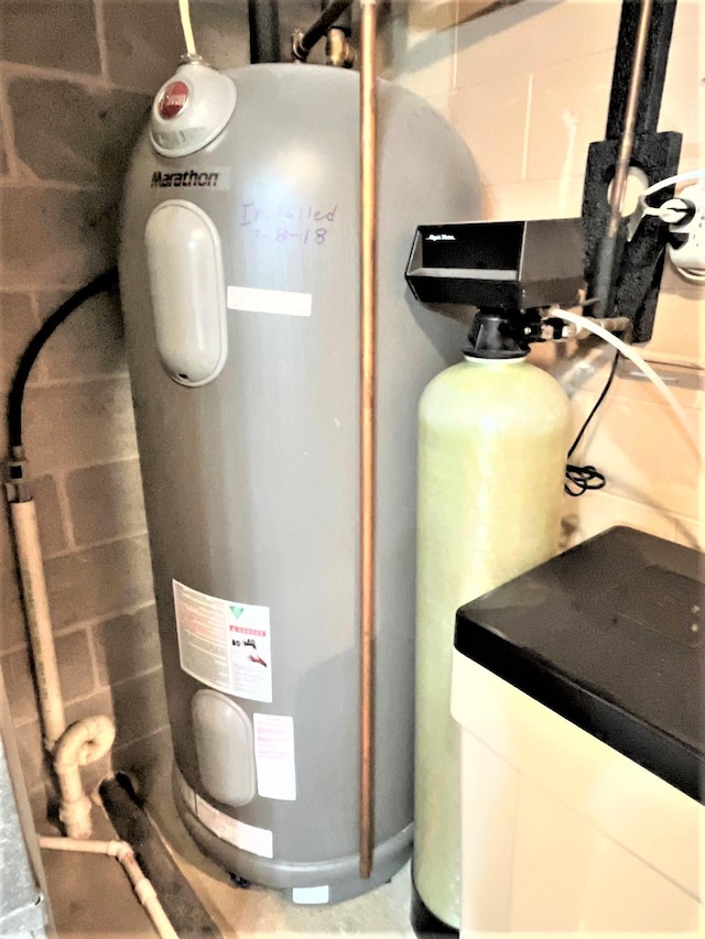 utility room featuring water heater