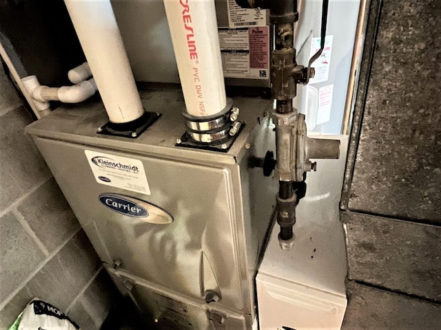 utility room featuring heating unit