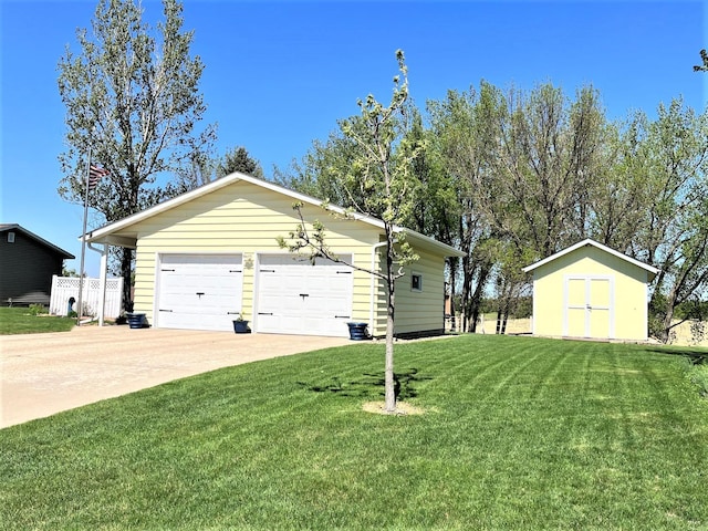 view of side of property with a garage, a lawn, an outbuilding, driveway, and a storage unit