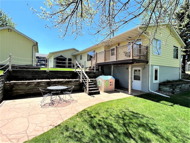 rear view of property featuring a patio area, stairway, a yard, and a wooden deck