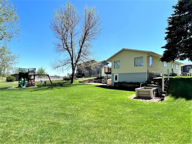 view of grassy yard with a playground
