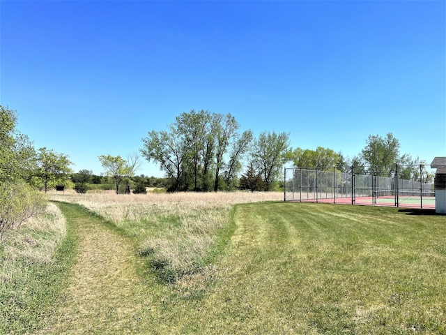 view of yard with a tennis court