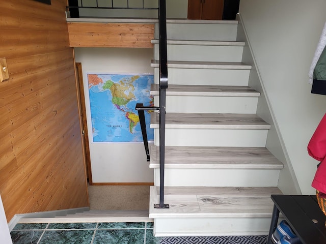 5344 Shady Ln, Canosia Twp, MN 55811 - staircase featuring tile patterned flooring, wood walls, and baseboards