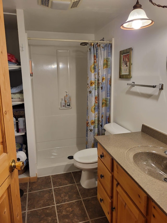 5344 Shady Ln, Canosia Twp, MN 55811 - full bathroom with vanity, toilet, tile patterned flooring, and a shower stall