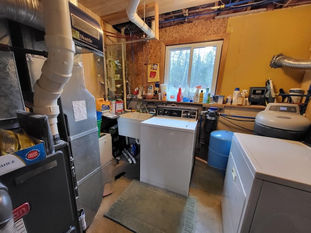 5344 Shady Ln, Canosia Twp, MN 55811 - laundry area with heating unit, laundry area, washer and clothes dryer, and a sink