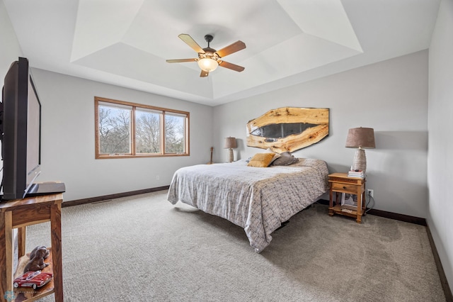 134 Newport Pkwy N, Kindred, ND 58051 - carpeted bedroom with a tray ceiling, ceiling fan, and baseboards