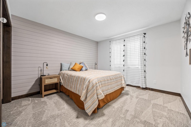 134 Newport Pkwy N, Kindred, ND 58051 - bedroom with baseboards, wood walls, and light colored carpet