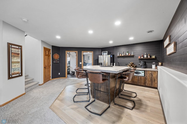 134 Newport Pkwy N, Kindred, ND 58051 - bar with recessed lighting, baseboards, wet bar, stainless steel fridge with ice dispenser, and stairway