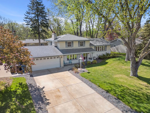 view of front of property featuring a chimney, an attached garage, driveway, and a front lawn