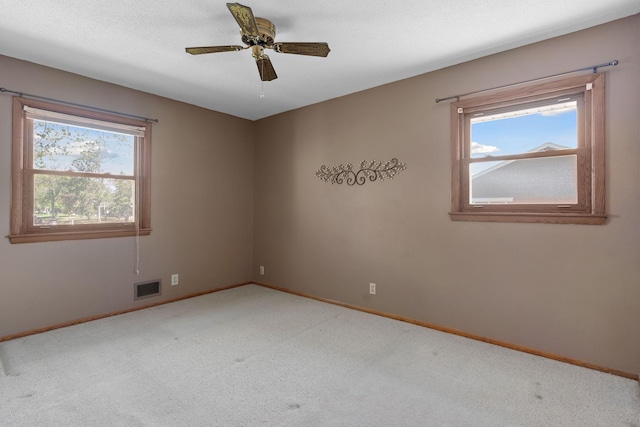 unfurnished room featuring baseboards, carpet, and a ceiling fan