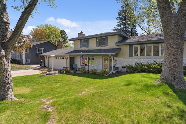 tri-level home featuring stucco siding, a front lawn, a chimney, an attached garage, and brick siding