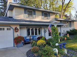 view of front of property with a garage, a chimney, and concrete driveway