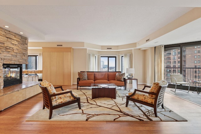 1235 Yale Pl Unit 1706, Minneapolis, MN 55403 - living room featuring a fireplace, wood finished floors, and visible vents