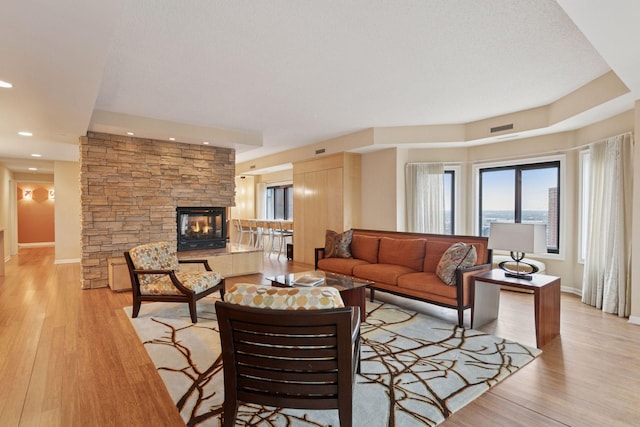 1235 Yale Pl Unit 1706, Minneapolis, MN 55403 - living room with baseboards, visible vents, light wood-style flooring, and a fireplace