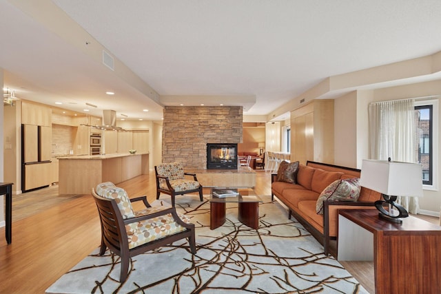 1235 Yale Pl Unit 1706, Minneapolis, MN 55403 - living room with a fireplace, recessed lighting, visible vents, and light wood-type flooring