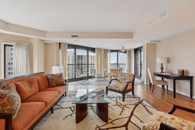 1235 Yale Pl Unit 1706, Minneapolis, MN 55403 - living room featuring baseboards, light wood finished floors, a textured ceiling, and visible vents