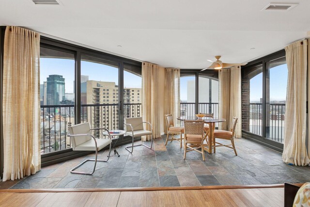 1235 Yale Pl Unit 1706, Minneapolis, MN 55403 - sunroom / solarium featuring a view of city, visible vents, stone finish floor, and expansive windows