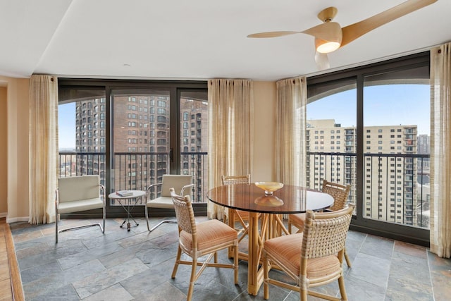 1235 Yale Pl Unit 1706, Minneapolis, MN 55403 - dining area featuring a wall of windows, baseboards, a city view, and stone tile floors