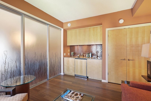 1235 Yale Pl Unit 1706, Minneapolis, MN 55403 - bar with baseboards, dark wood-type flooring, bar, tasteful backsplash, and paneled dishwasher