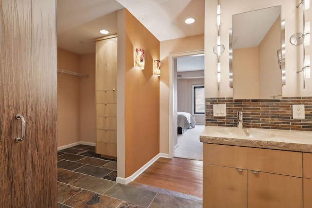 1235 Yale Pl Unit 1706, Minneapolis, MN 55403 - bathroom with baseboards, vanity, and a spacious closet