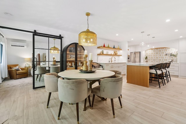 215 Barry Ave S Unit 116And 114, Wayzata, MN 55391 - dining room with a wall mounted air conditioner, a barn door, recessed lighting, and light wood-style floors