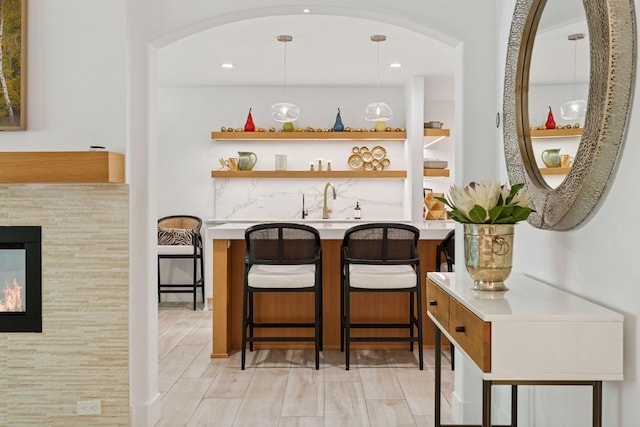 215 Barry Ave S Unit 116And 114, Wayzata, MN 55391 - bar featuring arched walkways, a sink, pendant lighting, and recessed lighting