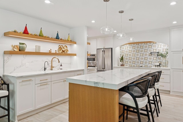 215 Barry Ave S Unit 116And 114, Wayzata, MN 55391 - kitchen featuring appliances with stainless steel finishes, a sink, open shelves, backsplash, and recessed lighting