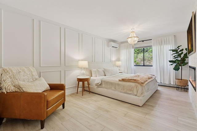 215 Barry Ave S Unit 116And 114, Wayzata, MN 55391 - bedroom featuring a decorative wall, an AC wall unit, and light wood-style floors