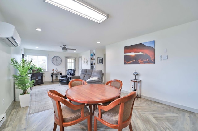 dining space featuring baseboards, a wall mounted AC, and baseboard heating