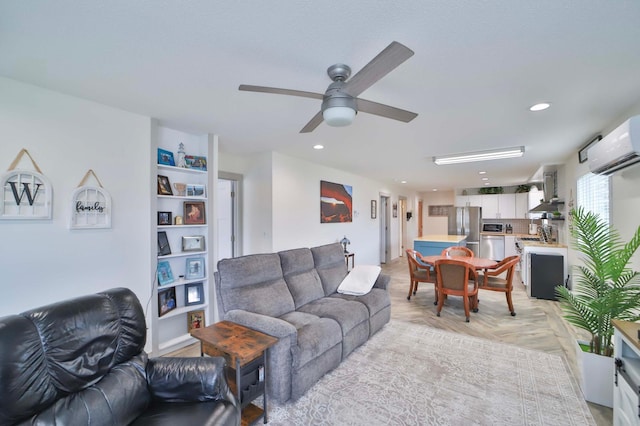 living room with recessed lighting, a wall mounted air conditioner, and a ceiling fan