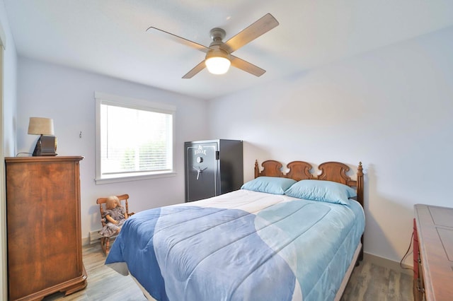 bedroom featuring baseboards, ceiling fan, and wood finished floors