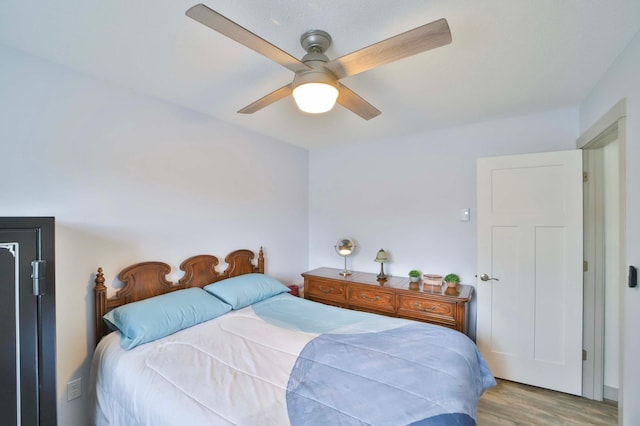 bedroom featuring light wood-type flooring and a ceiling fan
