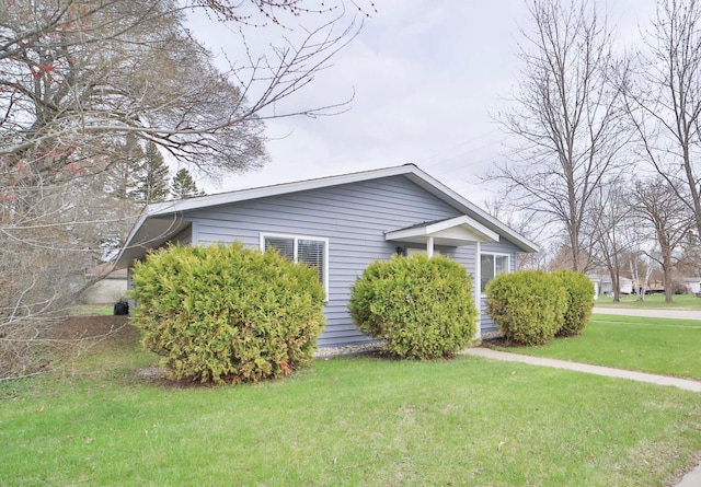 view of home's exterior with a yard
