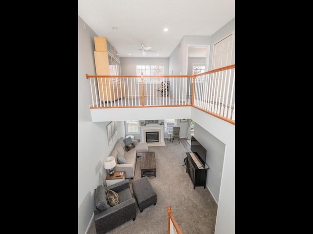carpeted living area with recessed lighting, ceiling fan, a healthy amount of sunlight, and a fireplace
