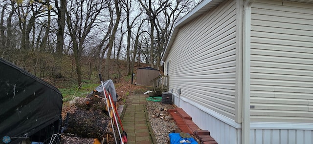 view of home's exterior featuring a storage shed, central AC unit, and an outdoor structure