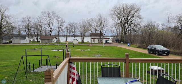 wooden terrace featuring a lawn
