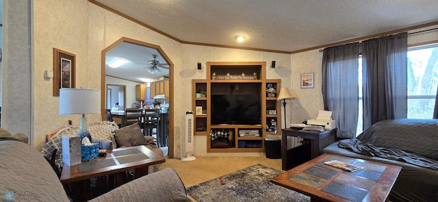 living area with crown molding, lofted ceiling, ceiling fan, a textured ceiling, and carpet flooring