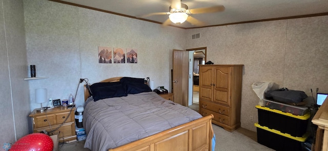 bedroom with crown molding, carpet flooring, ceiling fan, and visible vents
