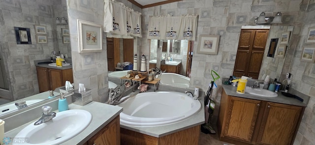 bathroom with two vanities, ornamental molding, a sink, and a garden tub