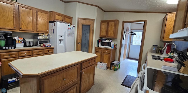 kitchen featuring crown molding, brown cabinets, white appliances, and light floors